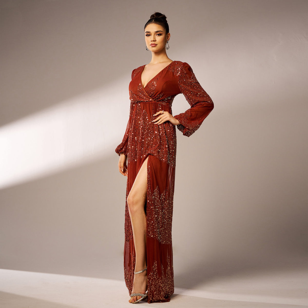 Rust sequin maxi dress hand on hip showing slit