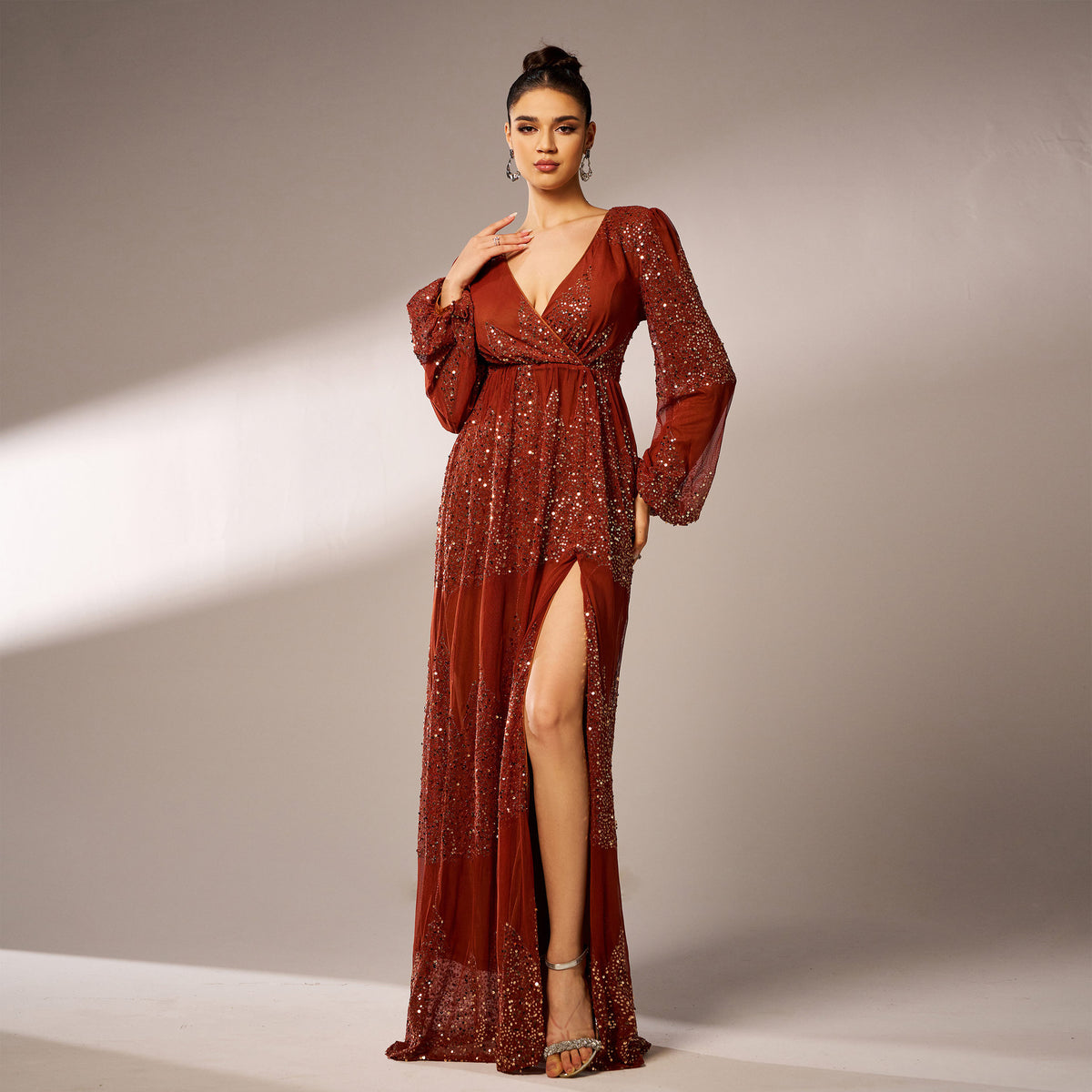 Rust sequin maxi dress walking pose with slit