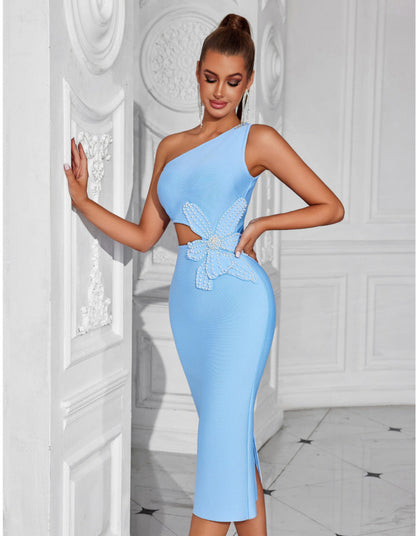 Woman wearing a light blue one-shoulder dress with lace details in an elegant interior setting.