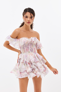 Woman wearing a floral off-shoulder dress on a white background