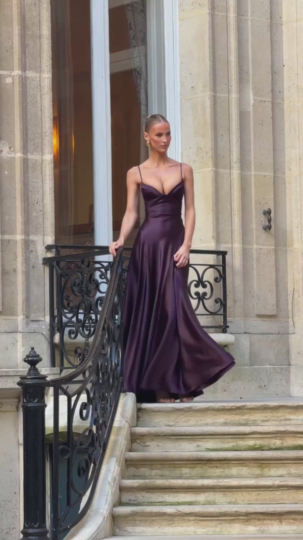 Alana satin gown in Dark Purple walking down stone stairs